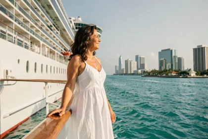 Femme sur le pont d'un paquebot de croisière quittant le port de Miami vers les Caraïbes